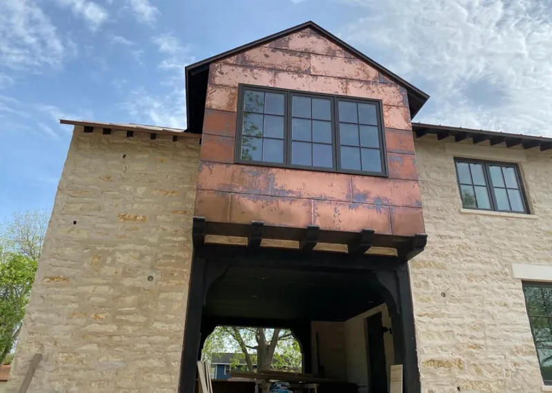 Copper metal panel facade on a stone building for Skylight Installation in Sharonville